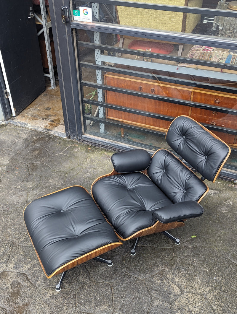 Restoration of pair of original Charles Eames chairs with ottomans