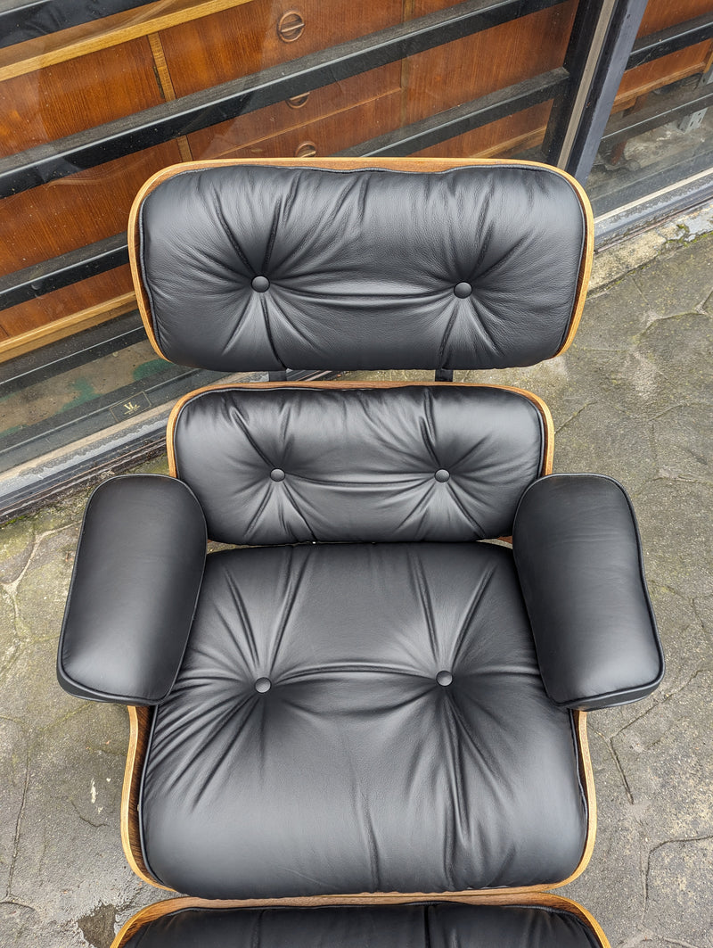 Restoration of pair of original Charles Eames chairs with ottomans