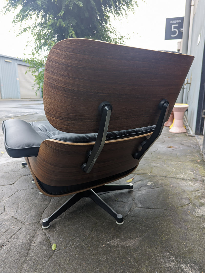Restoration of pair of original Charles Eames chairs with ottomans