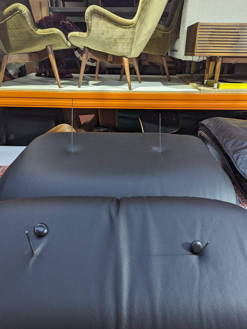 Restoration of pair of original Charles Eames chairs with ottomans