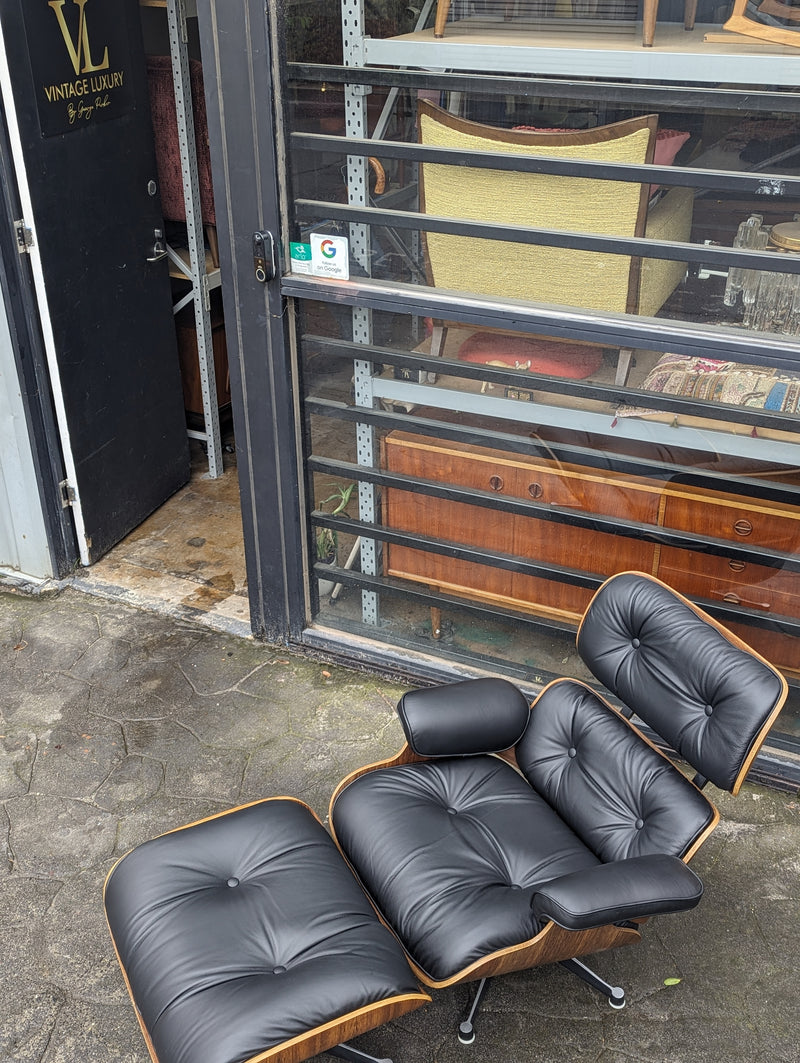 Restoration of pair of original Charles Eames chairs with ottomans