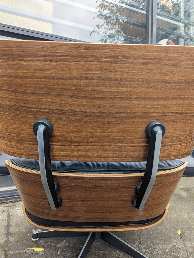 Restoration of pair of original Charles Eames chairs with ottomans