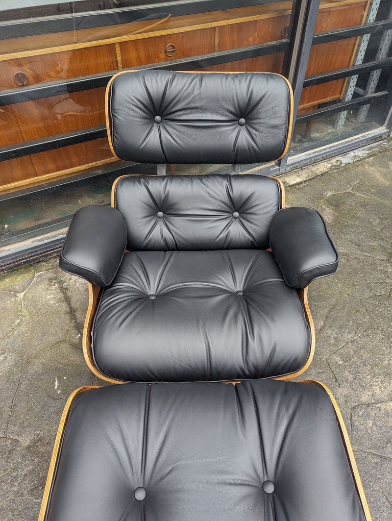 Restoration of pair of original Charles Eames chairs with ottomans