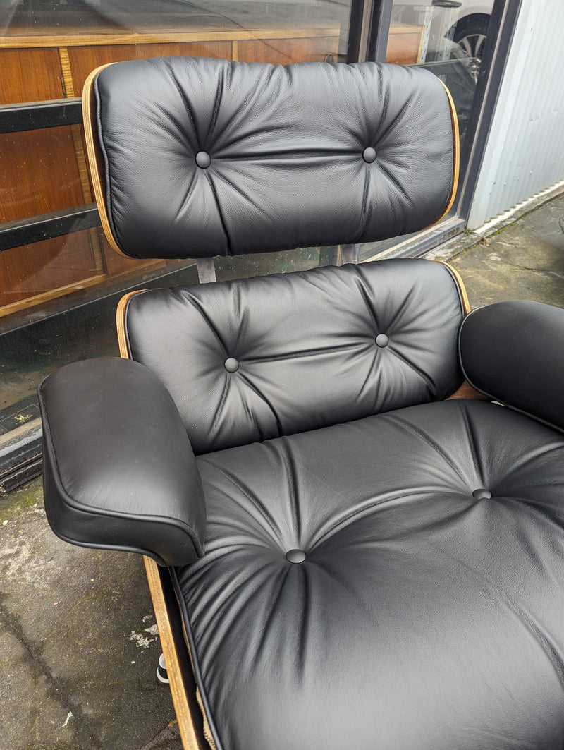 Restoration of pair of original Charles Eames chairs with ottomans