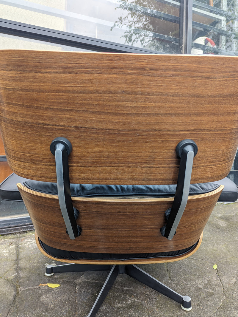 Restoration of pair of original Charles Eames chairs with ottomans